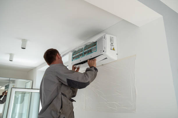 man installing a mini split